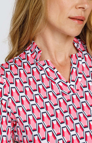 Detailed view of the star collar neckline, showing three distinct points on either side of the neck and in the center. The print is a geometric pattern of 6-sided gemstones in a light pink color on a white background.