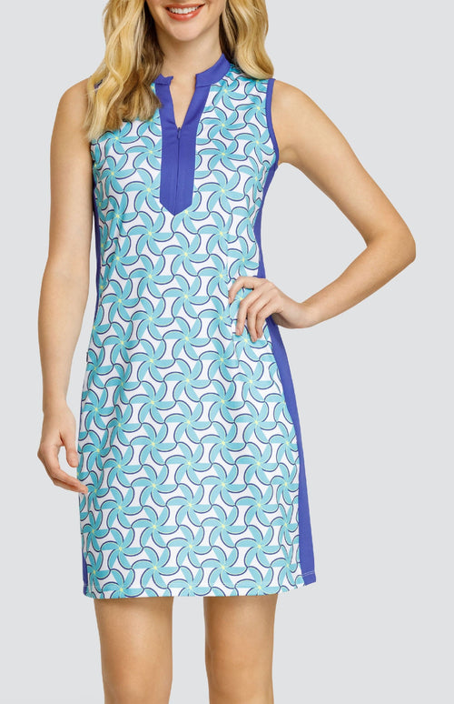 Model wearing a sleeveless dress with a spiral floral pattern in turquoise and blue on a white background.