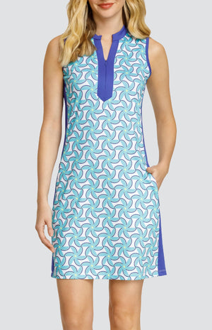 Model wearing a sleeveless dress with a spiral floral pattern in turquoise and blue on a white background.