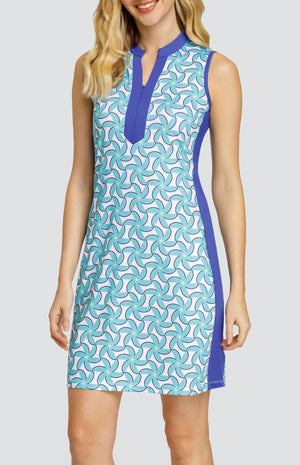 Model wearing a sleeveless dress with a spiral floral pattern in turquoise and blue on a white background.