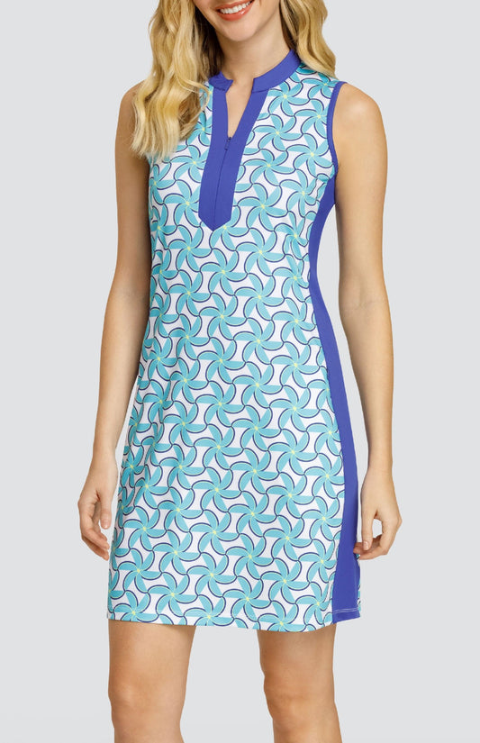 Model wearing a sleeveless dress with a spiral floral pattern in turquoise and blue on a white background.