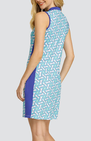 Model wearing a sleeveless dress with a spiral floral pattern in turquoise and blue on a white background.
